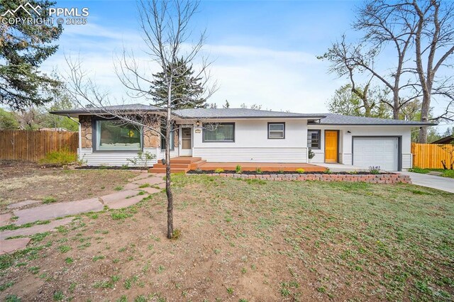 137 N 14th St, Colorado Springs, CO 80904 - single story home with fence, a garage, stucco siding, a front yard, and concrete driveway