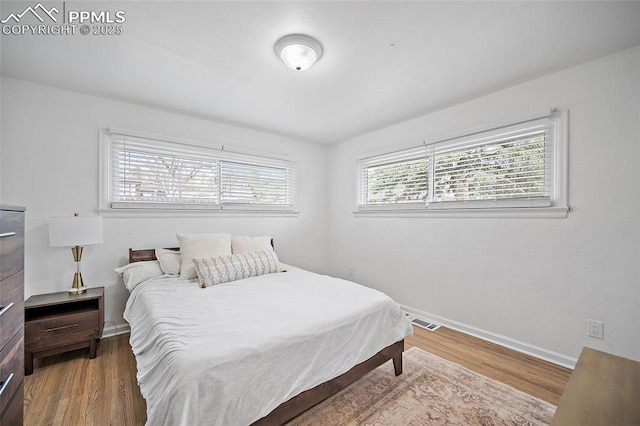 137 N 14th St, Colorado Springs, CO 80904 - bedroom featuring baseboards, visible vents, and wood finished floors