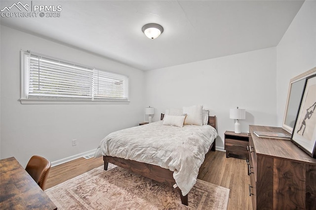137 N 14th St, Colorado Springs, CO 80904 - bedroom with baseboards, visible vents, and wood finished floors