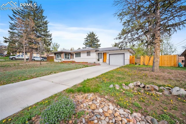 137 N 14th St, Colorado Springs, CO 80904 - ranch-style home with fence, an attached garage, concrete driveway, and a front yard