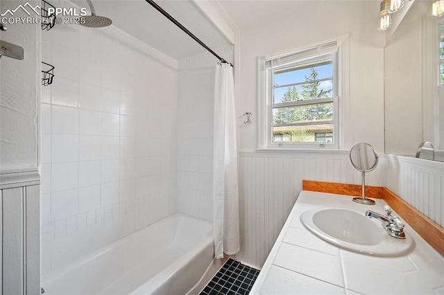 137 N 14th St, Colorado Springs, CO 80904 - full bath with tile patterned floors, a wainscoted wall, vanity, and shower / tub combo with curtain