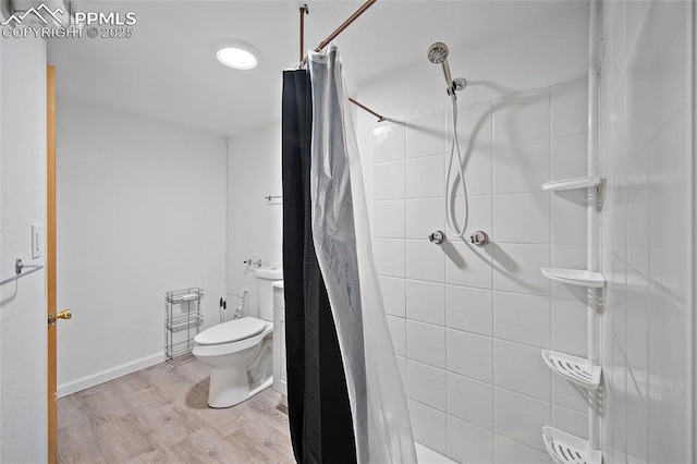 137 N 14th St, Colorado Springs, CO 80904 - bathroom with wood finished floors, a tile shower, and toilet