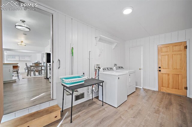 137 N 14th St, Colorado Springs, CO 80904 - clothes washing area with separate washer and dryer, laundry area, light wood-type flooring, and visible vents