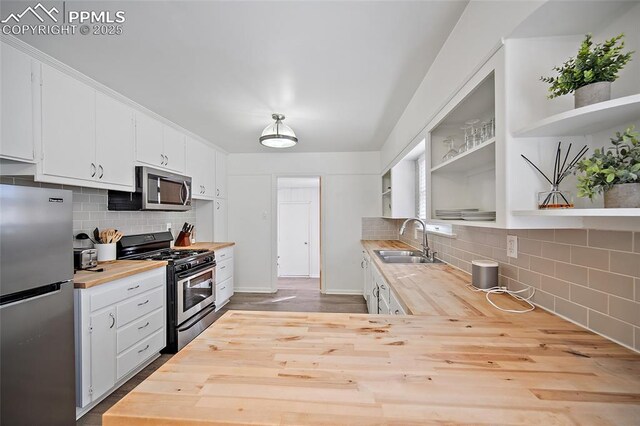 137 N 14th St, Colorado Springs, CO 80904 - kitchen featuring stainless steel appliances, open shelves, wooden counters, and a sink