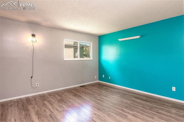 1950 Rusty Hinge Dr, Colorado Springs, CO 80920 - unfurnished room with wood finished floors, a textured ceiling, and baseboards