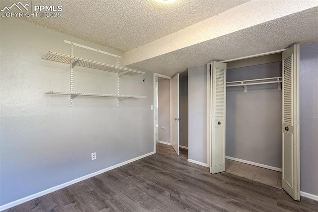 1950 Rusty Hinge Dr, Colorado Springs, CO 80920 - unfurnished bedroom featuring wood finished floors, a closet, baseboards, and a textured ceiling
