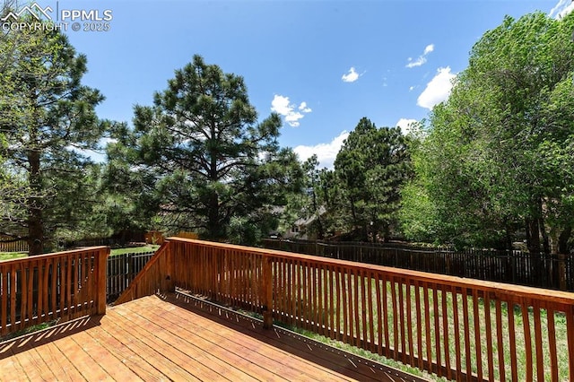 1950 Rusty Hinge Dr, Colorado Springs, CO 80920 - wooden deck with a fenced backyard and view of wooded area