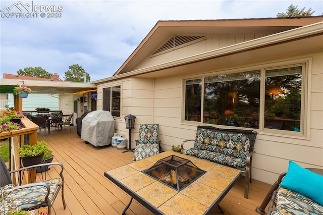 1522 Lehmberg Blvd, Colorado Springs, CO 80915 - wooden deck featuring outdoor dining space, a fire pit, and grilling area