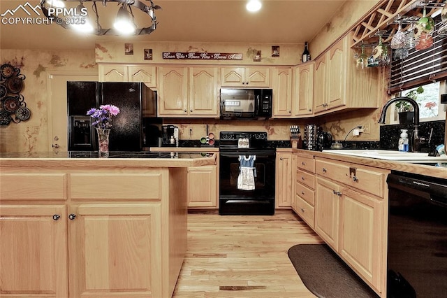 1522 Lehmberg Blvd, Colorado Springs, CO 80915 - kitchen with black appliances, light brown cabinetry, light wood-style flooring, and tasteful backsplash