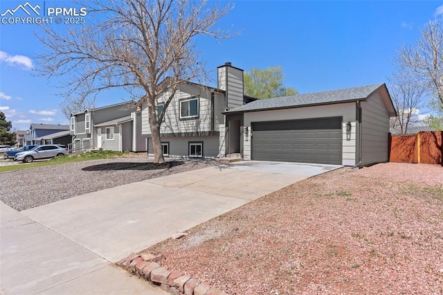 929 Bromefield Dr, Fountain, CO 80817 - view of front facade featuring a garage, fence, a chimney, and concrete driveway