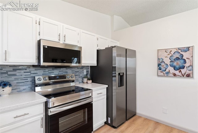 929 Bromefield Dr, Fountain, CO 80817 - kitchen with light wood finished floors, light countertops, stainless steel appliances, white cabinetry, and tasteful backsplash