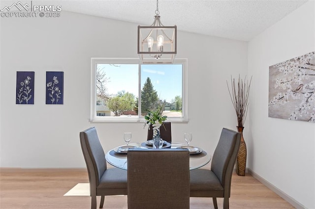 929 Bromefield Dr, Fountain, CO 80817 - dining room with an inviting chandelier, a textured ceiling, baseboards, and wood finished floors