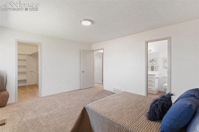 929 Bromefield Dr, Fountain, CO 80817 - bedroom with visible vents, light carpet, a textured ceiling, and a spacious closet
