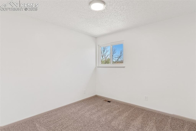 929 Bromefield Dr, Fountain, CO 80817 - carpeted empty room with visible vents, a textured ceiling, and baseboards