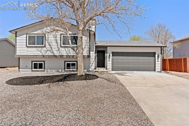 929 Bromefield Dr, Fountain, CO 80817 - tri-level home featuring concrete driveway, an attached garage, and fence
