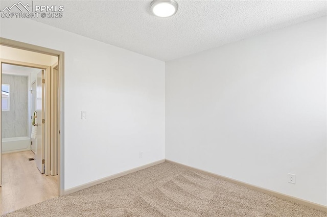 929 Bromefield Dr, Fountain, CO 80817 - spare room featuring a textured ceiling, light colored carpet, and baseboards