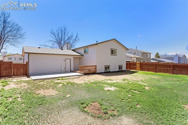 929 Bromefield Dr, Fountain, CO 80817 - back of house with a yard, a chimney, and a fenced backyard