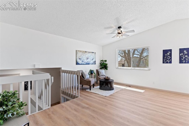 929 Bromefield Dr, Fountain, CO 80817 - sitting room with wood finished floors, lofted ceiling, ceiling fan, a textured ceiling, and an upstairs landing