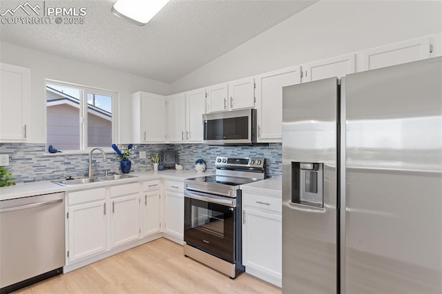 929 Bromefield Dr, Fountain, CO 80817 - kitchen with a sink, appliances with stainless steel finishes, decorative backsplash, and white cabinets