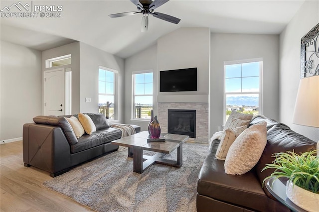 9484 Simper Hts, Colorado Springs, CO 80924 - living area with wood finished floors, ceiling fan, a glass covered fireplace, baseboards, and lofted ceiling