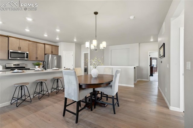 9484 Simper Hts, Colorado Springs, CO 80924 - dining room with light wood-style flooring, a chandelier, recessed lighting, and baseboards
