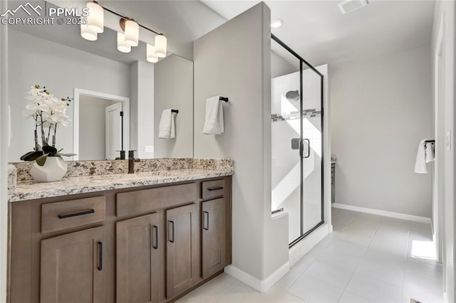 9484 Simper Hts, Colorado Springs, CO 80924 - bathroom featuring vanity, a stall shower, baseboards, and tile patterned floors