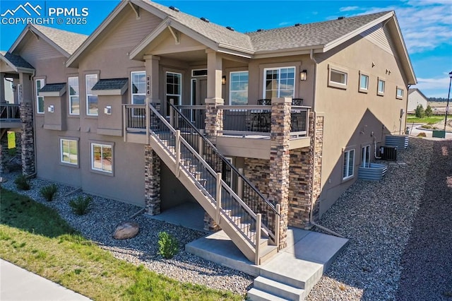 9484 Simper Hts, Colorado Springs, CO 80924 - view of front facade featuring stucco siding, stairway, and roof with shingles