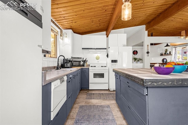 kitchen featuring white appliances, light wood-style floors, gray cabinets, under cabinet range hood, and a sink
