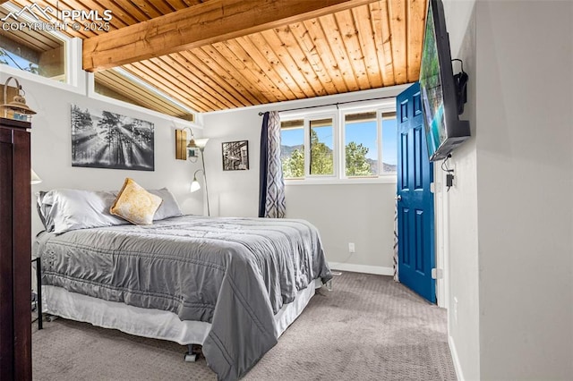 bedroom with carpet flooring, vaulted ceiling with beams, baseboards, and wood ceiling