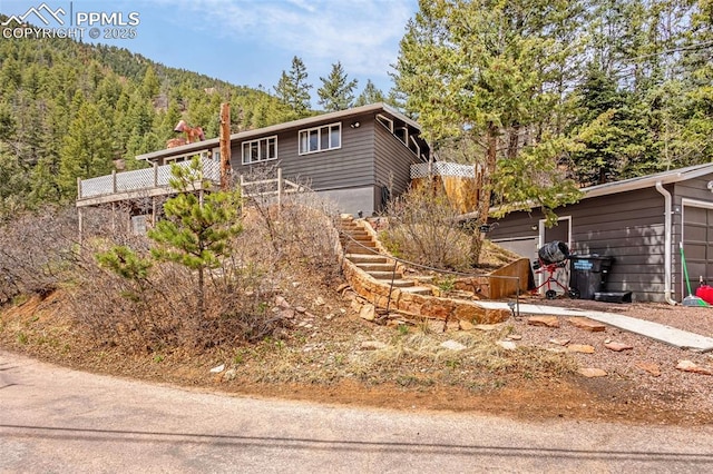 view of home's exterior with a view of trees