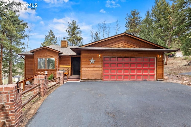 1200 Forest Edge Rd, Woodland Park, CO 80863 - chalet / cabin with fence, roof with shingles, and a chimney