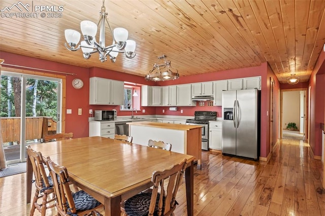 1200 Forest Edge Rd, Woodland Park, CO 80863 - dining space featuring an inviting chandelier, light wood finished floors, and wooden ceiling