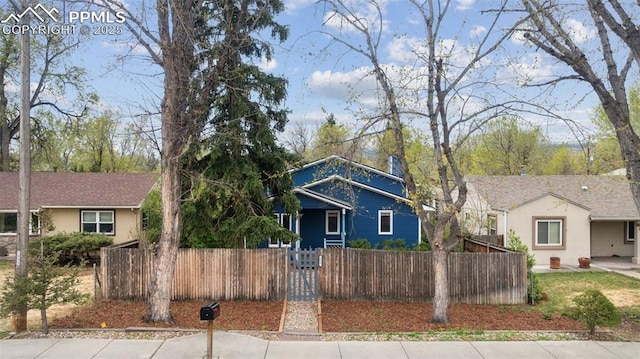 bungalow-style home with a fenced front yard and stucco siding