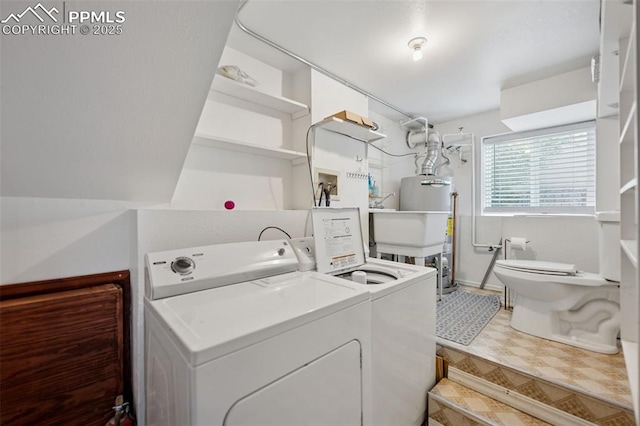 clothes washing area featuring a sink, laundry area, and washing machine and dryer
