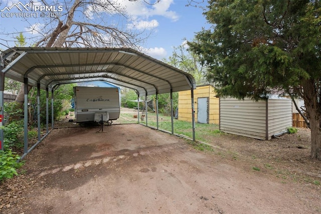 view of parking / parking lot featuring fence and a carport