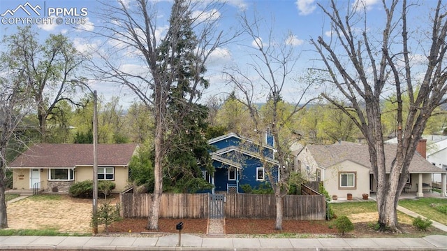 bungalow-style home with stucco siding and fence private yard