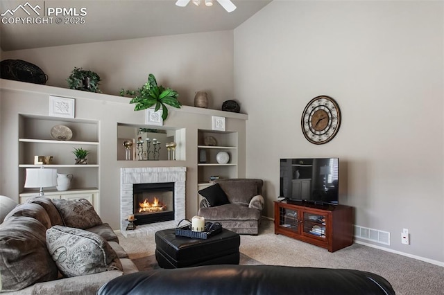 7820 Curlew Ct, Colorado Springs, CO 80920 - carpeted living area with a ceiling fan, visible vents, a fireplace, baseboards, and lofted ceiling