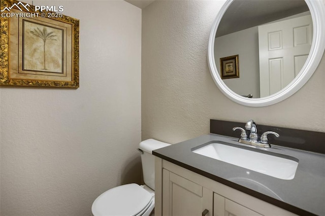 7820 Curlew Ct, Colorado Springs, CO 80920 - bathroom with vanity, a textured wall, and toilet