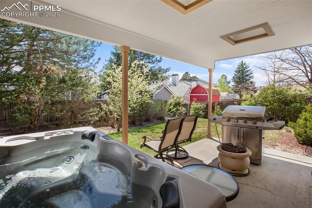 7820 Curlew Ct, Colorado Springs, CO 80920 - view of patio / terrace with a hot tub, a fenced backyard, and area for grilling