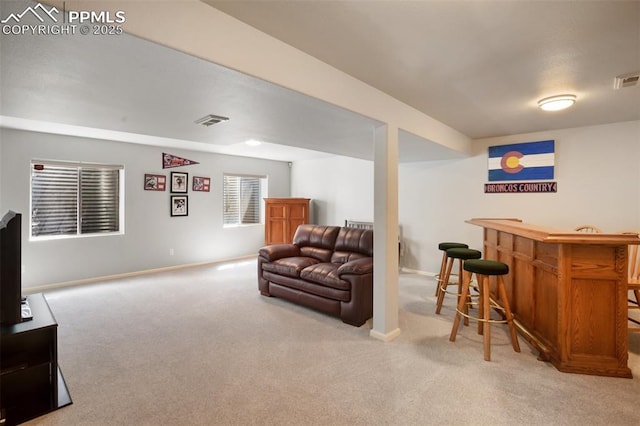 7820 Curlew Ct, Colorado Springs, CO 80920 - living room featuring carpet floors, baseboards, visible vents, and a bar