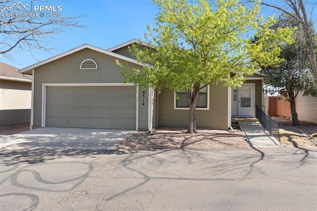 ranch-style house featuring a garage and driveway