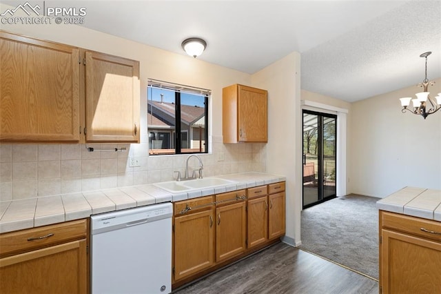 kitchen with decorative backsplash, dark wood-style flooring, white dishwasher, a sink, and an inviting chandelier