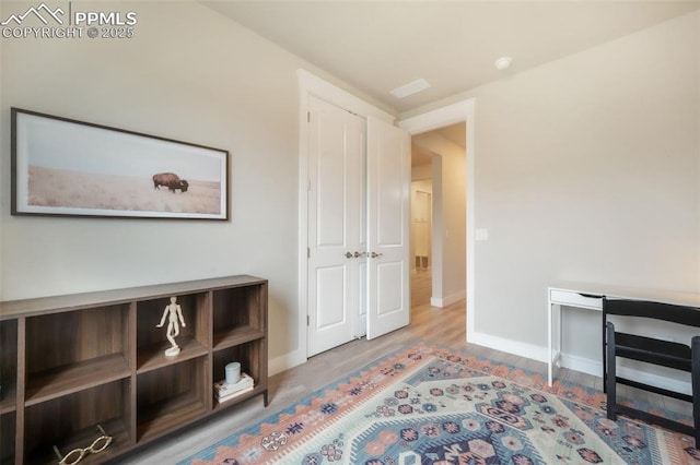 sitting room featuring baseboards and wood finished floors