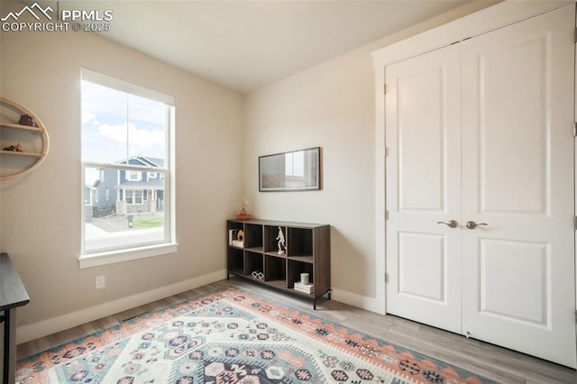 interior space with baseboards and wood finished floors