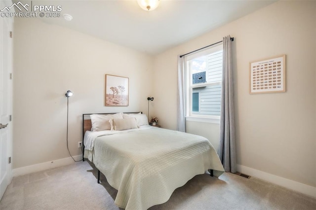 bedroom featuring baseboards and light colored carpet