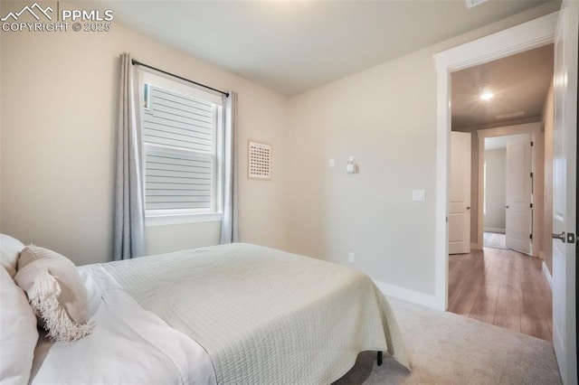 carpeted bedroom with baseboards