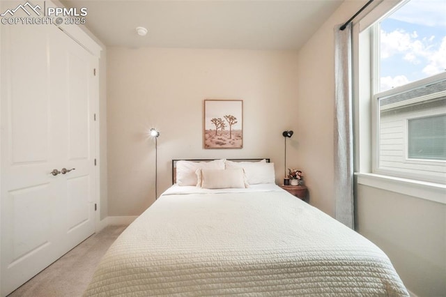 carpeted bedroom with baseboards