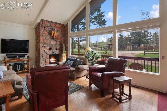 500 W Kellys Rd, Woodland Park, CO 80863 - living area featuring high vaulted ceiling, wood-type flooring, a fireplace, and wooden ceiling with exposed beams