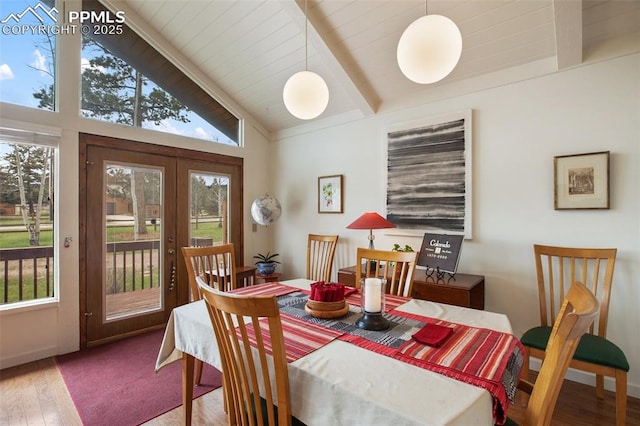 500 W Kellys Rd, Woodland Park, CO 80863 - dining area with beamed ceiling, wood finished floors, french doors, and high vaulted ceiling