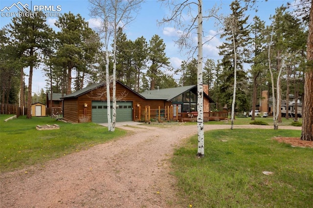 500 W Kellys Rd, Woodland Park, CO 80863 - view of front of home featuring dirt driveway, a front lawn, and a garage